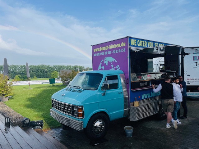 Dodge-with-guests-in-front-of-rainbow